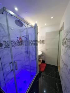 a bathroom with a shower with a glass door at Piazza Colombo-Apartments in Sanremo