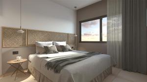 a bedroom with a large bed and a window at Elafonisi Resort by Kalomirakis Family in Elafonisi