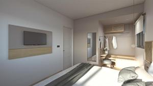 a bedroom with a bed and a tv on a wall at Elafonisi Resort by Kalomirakis Family in Elafonisi
