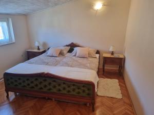 a bedroom with a large bed with two night stands at Greenview Apartment with Parking in Rovinj