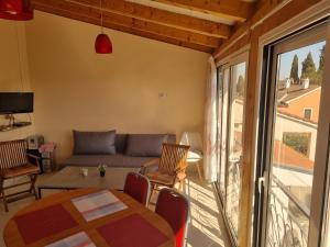 a living room with a couch and a table at Greenview Apartment with Parking in Rovinj