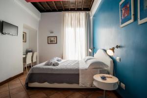 Ένα ή περισσότερα κρεβάτια σε δωμάτιο στο SWEETSUITE Rome