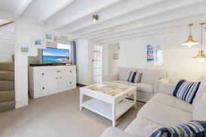 a living room with a couch and a table at White Sails in Brixham