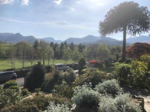a view of a garden with mountains in the background at Crow Park Hotel in Keswick