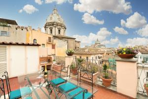 a balcony with chairs and a view of the city at Rooftop Campo dei Fiori in Rome