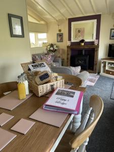 a living room with a table with books on it at The Retreat at The Inn in Spilsby