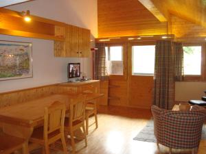 a kitchen with a table and chairs in a room at Résidence Tarcianne in Grimentz