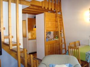 a room with a bunk bed and a kitchen at Résidence Tarcianne in Grimentz