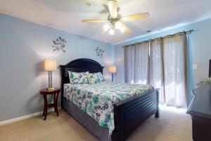 a bedroom with a bed and a ceiling fan at Seaside - Silver Lining 202B in Virginia Beach +15 photos