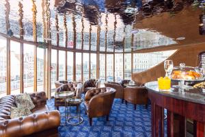 a restaurant with leather chairs and a bar with a view at Ocean Mist Leith in Edinburgh