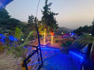 a view of a park at night with lights at Hotel Himalayan Village in Mussoorie