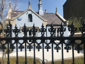a black fence in front of a church at Wellington Cottage in Wexford