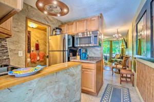 a kitchen with a counter top and a refrigerator at GARDEN VIEW STUDIO - KONA ISLANDER INN CONDOS condo in Kailua-Kona
