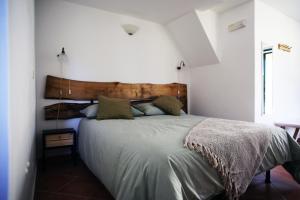 a bedroom with a large bed with a wooden headboard at Masseria Procacci in Ischitella