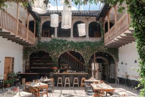 a restaurant with tables and chairs in front of a building at Casa Tunki in Cusco