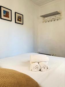 a bedroom with a bed with two towels on it at New Charming Flat - Lisbon Center in Lisbon