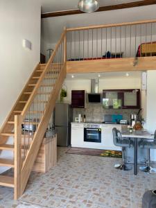 a kitchen with a staircase and a living room at Spaß & Ferien auf dem Alpaka Hof 2 in Lenschow