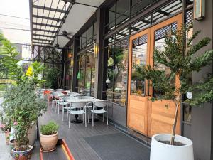 una fila de mesas y sillas fuera de un restaurante en Sacha's Hotel Uno SHA en Bangkok