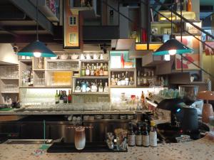 a kitchen with a bar with a lot of drinks at Sacha's Hotel Uno SHA in Bangkok