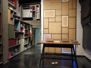 a library with a table with two laptops on it at Sacha's Hotel Uno SHA in Bangkok