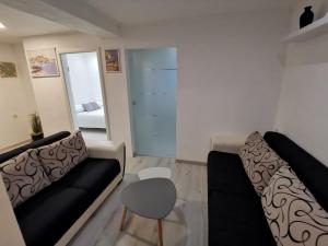 a living room with a couch and a chair at Braavos apartments Šibenik Deluxe near Marina in Šibenik