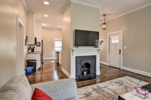 a living room with a fireplace with a flat screen tv at Ideally Located Penne Place with Deck and Grill in Greenville