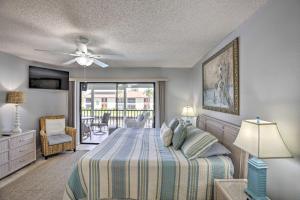 a bedroom with a bed and a balcony at Pool and Canal Access Central Cape Coral Condo! in Cape Coral +25 photos