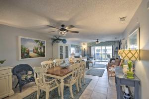 a dining room and living room with a table and chairs at Pool and Canal Access Central Cape Coral Condo! in Cape Coral