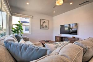 a living room with a couch and a flat screen tv at Charming San Diego Apartment - Walk to Bay! in San Diego