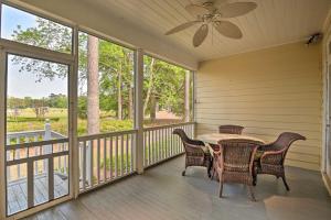 a screened porch with a table and chairs on it at Cottage with Deck and Pool Access about 6 Mi to Beach in Myrtle Beach