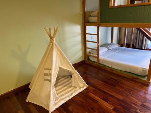 a teepee tent in a room with a bunk bed at Hotel Saint George in Puerto Iguazú