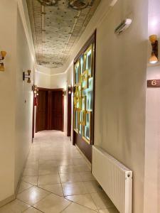 a hallway with a tile floor and a ceiling at Augustos in Thessaloniki