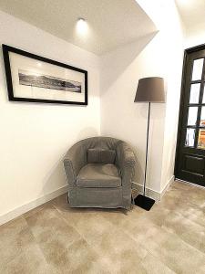 a chair and a lamp in a living room at Residencial Douro in Peso da Régua