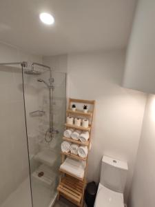 a bathroom with a shower and a toilet and towels at Residencial Douro in Peso da Régua +59 photos