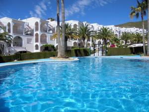 una gran piscina con palmeras y edificios en Calas Holidays Literas, en Peñíscola
