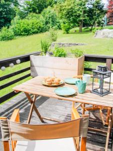 a wooden table with plates of food on it at Geographer´s Cottage in Siegsdorf