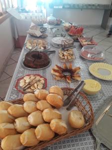 a table with bread and other food on it at Pousada Lorenise in Guriri +13 photos