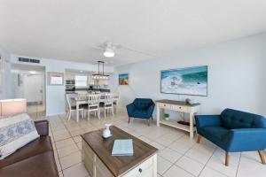 a living room with a couch and a table at Paradise Beach Club - Ground Floor & Townhouses in Satellite Beach