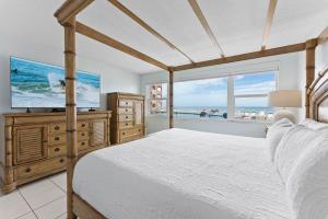 a bedroom with a bed and a flat screen tv at Paradise Beach Club - Ground Floor & Townhouses in Satellite Beach +179 photos