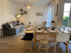 ein Wohnzimmer mit Tisch und Stühlen und einer Couch in der Unterkunft La Serrisienne 5 - Val d'Europe - Disneyland Paris - 6 à 8 Personnes in Serris + 16 Fotos