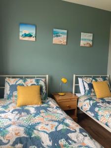 a bedroom with two beds and a night stand at 2 Sea crest Bundoran in Bundoran
