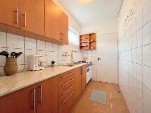 a kitchen with wooden cabinets and a sink in it at Holiday Home Szulok in Szulok +17 photos