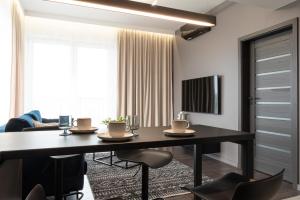 a dining room with a table and chairs at Apartamenty DES-Zator in Zator