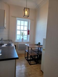 a kitchen with a table and a window in it at Sea View flat 2 with Fast WiFi and FREE parking in Scarborough
