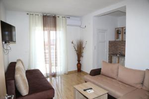 a living room with a couch and a table at Apartments Armini in Ulcinj