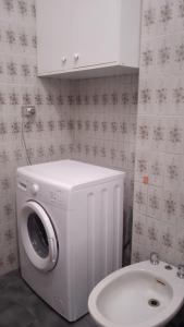 a washing machine and a toilet in a bathroom at Casa Elena II in Lerici