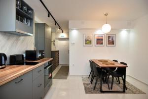 a kitchen with a table and chairs in a room at River&Bike Apartment with free electric bike in Belgrade