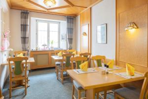 a dining room with wooden tables and chairs at AKZENT Hotel Meerfräulein in Wemding
