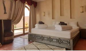 a bed with two pillows on it in a room at RIAD - Jnan Bnati - Pool in Marrakech