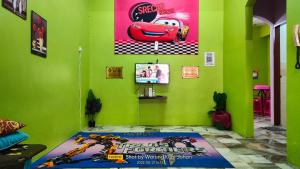 a room with a green wall with aesame street bedroom at Warung Kopi Johan Homes in Kuala Rompin